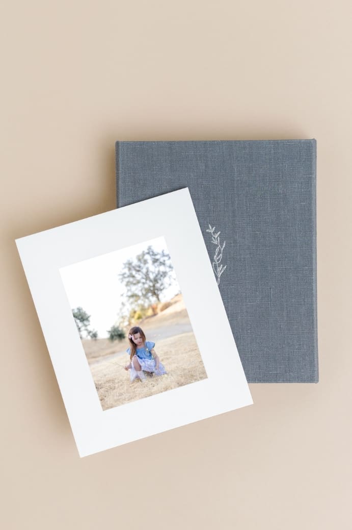 Light and Airy matted print sample showing a young girl playing with wildflowers during San Jose photoshoot