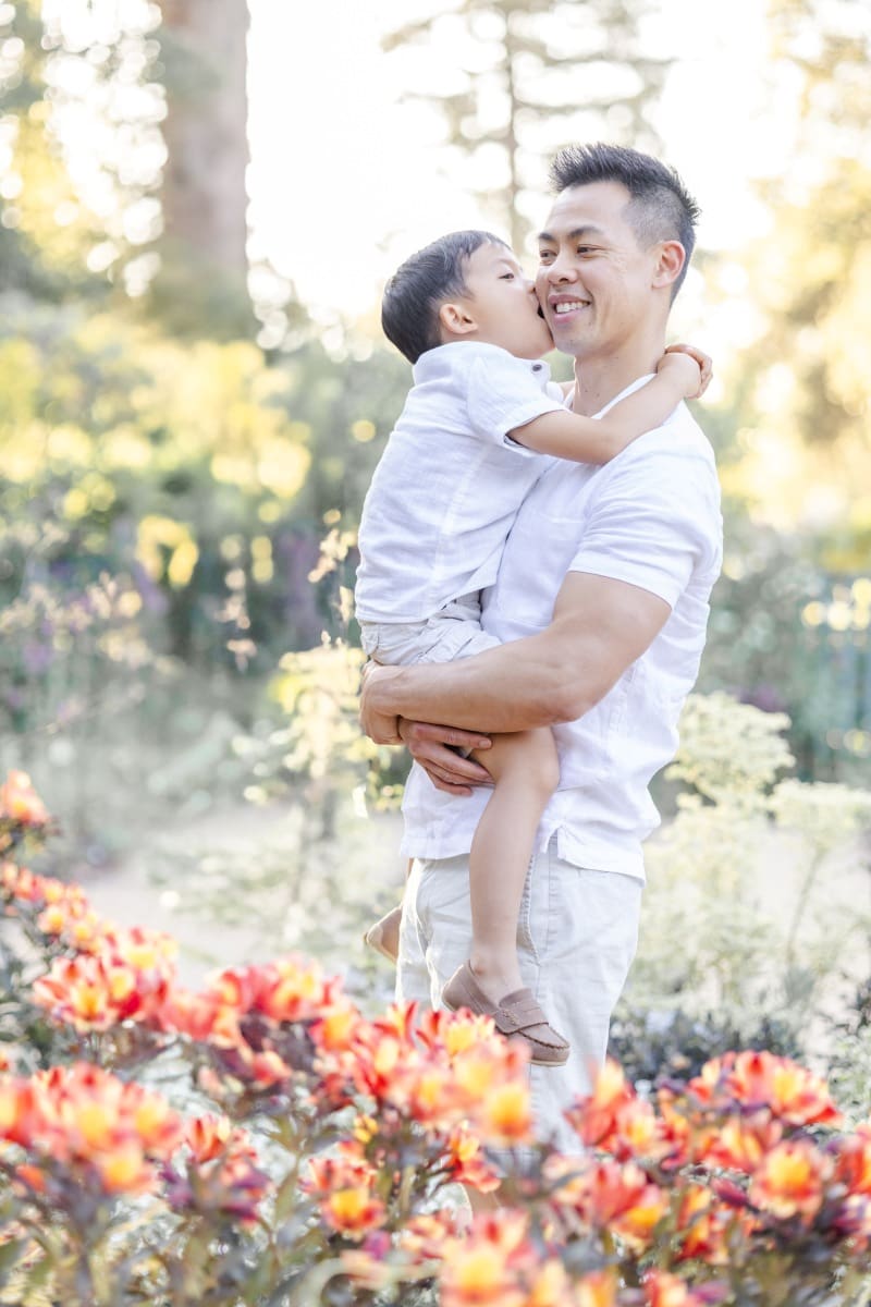toddler son kisses his dad during their bay area garden springfamily photoshoot
